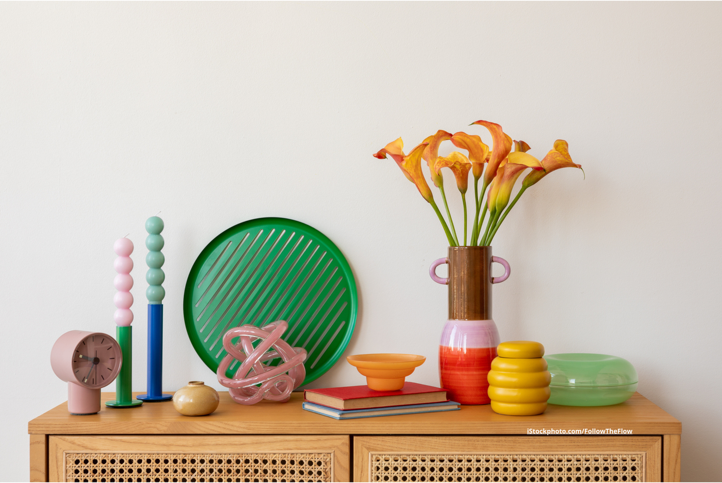 Farbenfrohes Regal mit bunten Vasen, Kunstobjekten und Wohnaccessoires im Stil des Dopamine Decor.